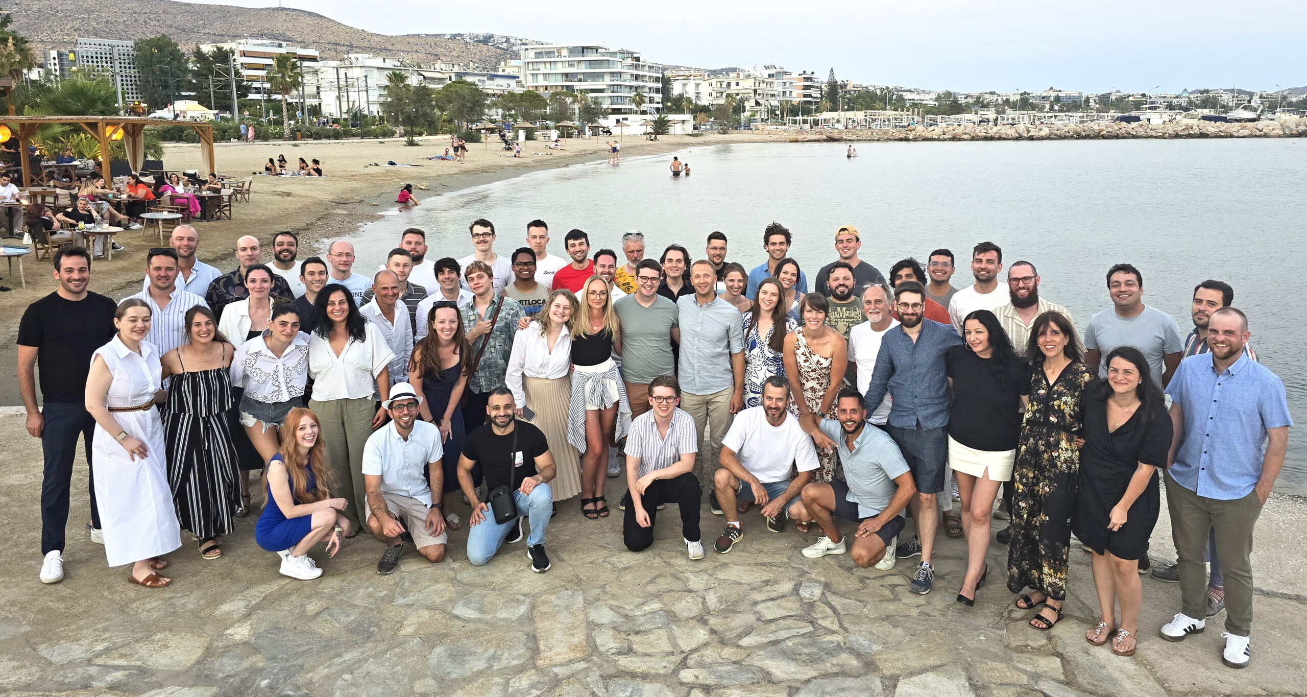 group photo of comet ai and mlops platform employees by the ocean